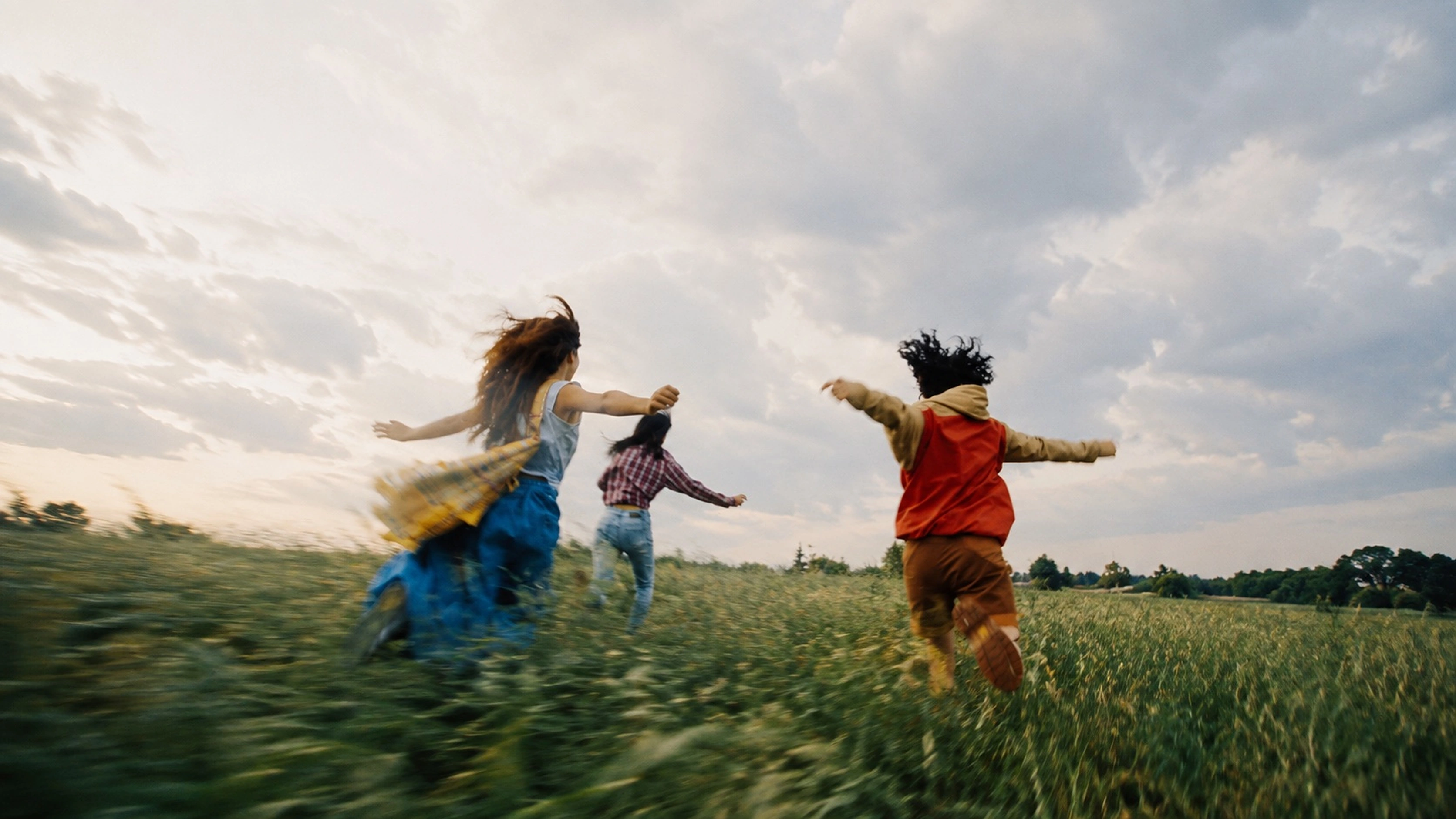 Children running together through an open field